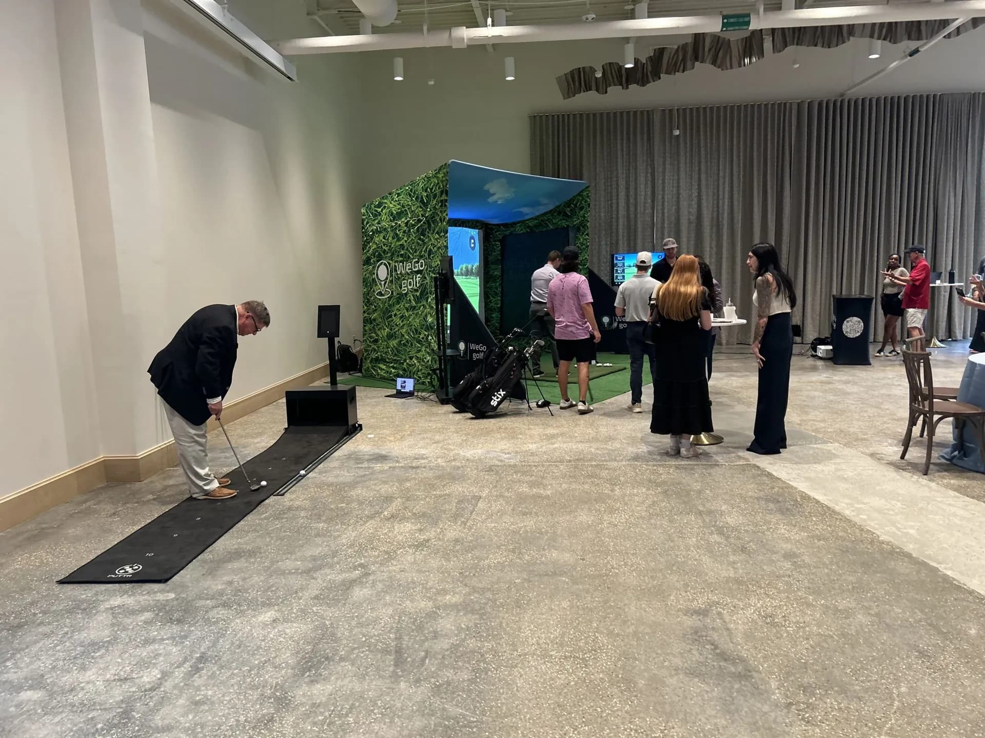 Branded WeGo Golf bays at a professional golf event