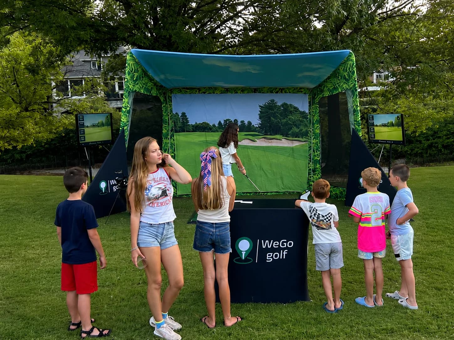 Kids lined up to take their swings at a WeGo Golf youth community event