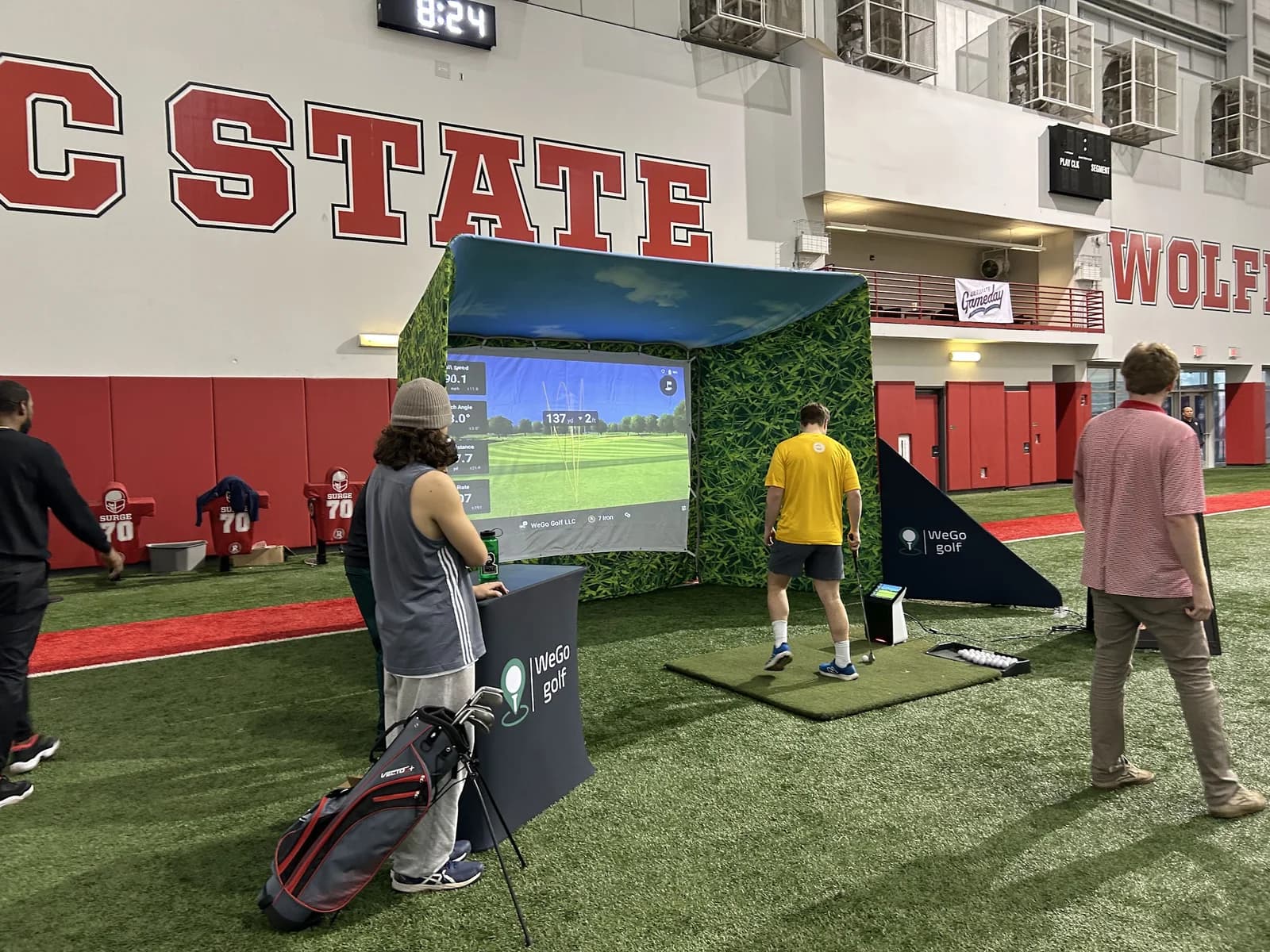 WeGo Golf activation on the field at the NC State Wolfpack indoor practice facility
